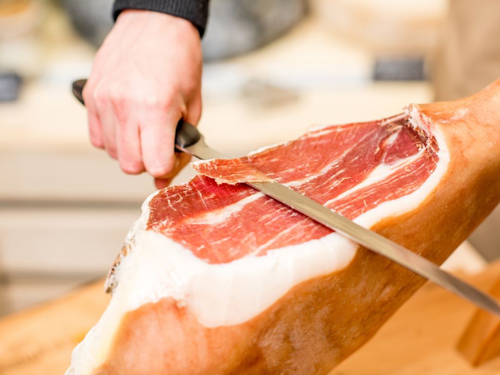 cutting prosciutto